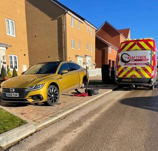 ASAP Tyres 247 van parked on a residential driveway while a wheel is changed on a customer's car